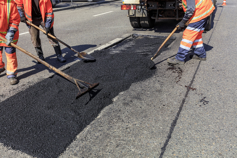 workers spreading the asphalt