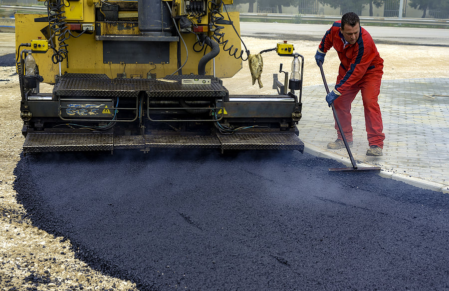 male worker spreading the asphalt